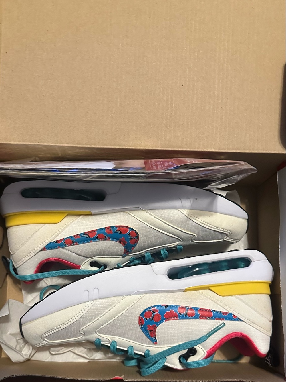 Nike White Sneakers with Teal Laces and Floral Swoosh